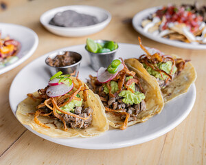 delicious mexican-style carne asada tacos with avocado and salsa
