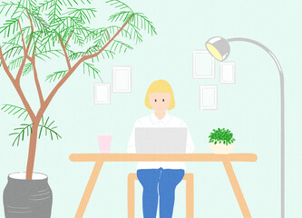 植物のある部屋で仕事をする女性