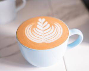 Hot coffee latte art with one cup left over