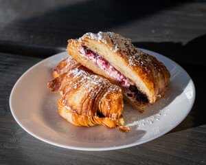 delicious croissant with cream cheese and raspberry inside