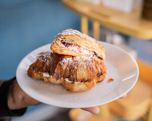 delicious croissant with cream cheese and raspberry inside