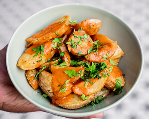 seasoned baby potatoes prepared in butter with hot sauce on top