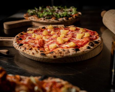 handmade hawaiian pizza with fresh ingredients right out of the oven