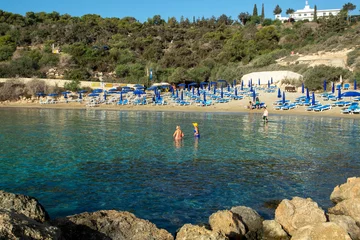  Crystal clear blue water of Mediterranean sea  and yellow rocks in on Konnos beach near Protaras, Cyprus © barmalini