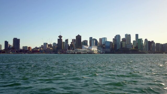 Taking the SeaBus ferry on Vancouver Harbour. Downtown skyline in the background. City of Vancouver, British Columbia, Canada.