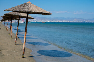 Beach unbrellas and chairs on sunny sandy beach Lady's mile in Akritori, Cyprus