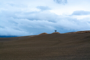 View on hills of Val d'Orcia, Tuscany, Italy. Tuscan landscape with ploughed fields in autumn.