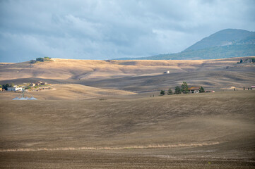 View on hills of Val d'Orcia, Tuscany, Italy. Tuscan landscape with ploughed fields in autumn.