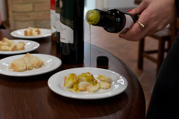 Tasting of Italian extra virgin olive oil with bread on organic farm in Tuscany, Italy