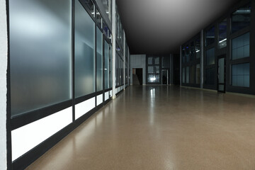 Modern empty office corridor with glass wall