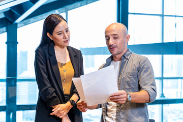 Banker is listening to customer list of requirement and benefit on mutual fund and insurance that...