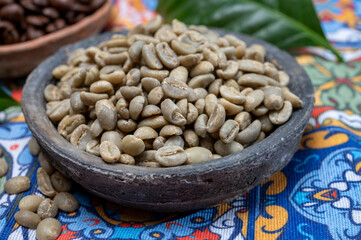 Green and roasted coffee beans from South America coffee producing region, from Colombia and Brazil with  mountain ranges and climate ideal for coffee growing