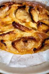 Baked apple cake with almond frangipani custard close up