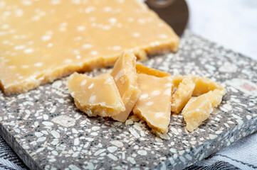 72 months very old Italian parmigiano-reggiano parmesan cheese from Parma has amber color, dry, extremely grainy and crumbly with very intense taste.