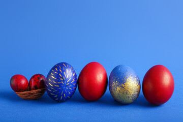 Stylish Easter eggs on blue background