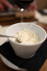 Bowl with grated parmesan Parmigiano-Reggiano hard cheese in Parma, Emilia Romagna, Italy