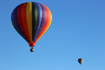 The colorful hot air balloons in a clear blue sky