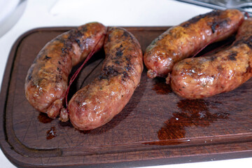 wood plank with sausage criollo argentinian dish - obrazy, fototapety, plakaty