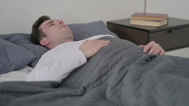 Man having Back Pain in Bed