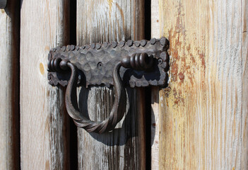 an old iron bracket on a wooden gate homemade shutter