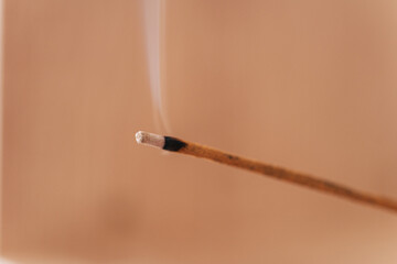 Smoldering incense close up against background.