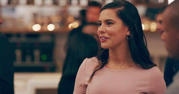 The natural habitat of social butterflies. Young people having drinks and being social in a club or party. Beautiful young caucasian woman talking to friends while enjoying a fun evening together