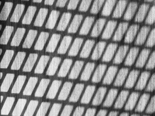 Black and white pattern shadow on wooden floor background.