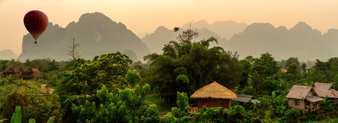 sunrise over the mountains with hot air balloon