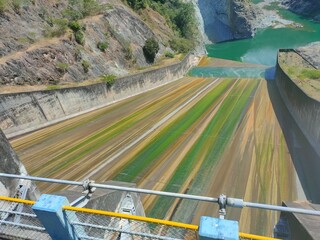 A colorful dam spillway