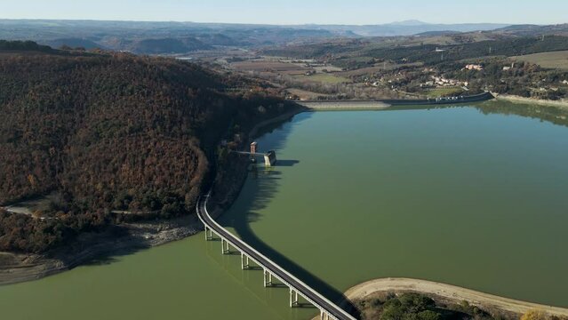 Aerial view of vehicles driving on the highway along Corbara lake (Lago di Corbara), Baschi, Terni, Italy.