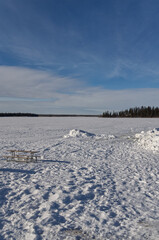 Fototapeta na wymiar Picnic Tables on a Frozen Lake