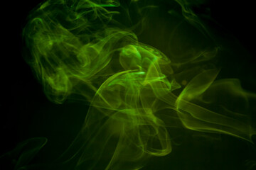 Green smoke on black background.