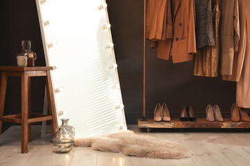 Fototapeta na wymiar Stylish mirror with light bulbs in dressing room. Interior design