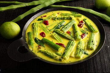 Moringa oleifera, muringa raw green mango curry. Kerala vegetarian recipes.