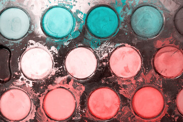 Big messy palette with dry pastel watercolor paints for the drawing activity. Hobby and leisure activity and arts backgrounds