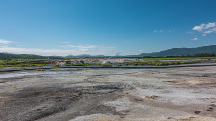Hot streams flow in the caldera of an extinct volcano. There are sulphurous deposits on the soil....