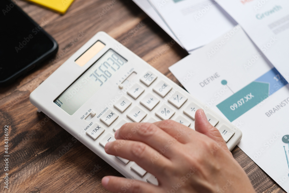 Poster close up hand using calculator calculate tax and budget of project at home