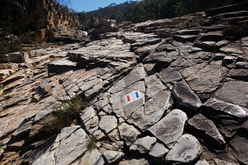 Blue and red arrows, on stones in the national park in the Brasil, shows the direction of forward...