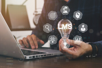 Horizontal banner close up successful businessman holding light bulb, LMS - Learning Management...