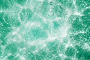 bright ripple surface of light blue swimming pool with sun reflect view from top see through floor ,abstract clean water glare detail for texture background or wallpaper