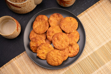 Japanese rice crackers or Senbei, Japan traditional snack, Senbei Japanese snack in black plate on wooden background