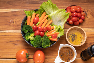 Fresh vegetable salad Lettuce, carrots, broccoli, green peas, fresh and tomatoes an appetizer before the main meal.