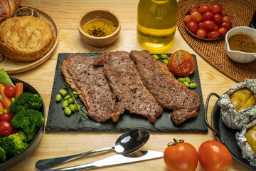 Kamui Wagyu Beef Strip Lloyd marble Steak Grill with fresh vegetaber salad, Baked Potatoes with butter