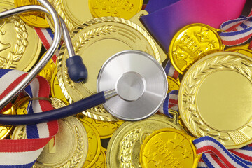 Stethoscope on gold medal background. Medicine and sport concept.