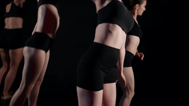 four modern ballerinas are rehearsing in dance class, dancing contemporary choreography