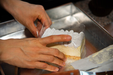 the woman pack the cake with her hand