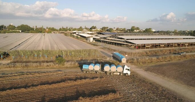 Kibbutz, Israel - 25 November 2021: Aerial view of lorries transporting cotton bales in a field, Kibbutz Saar, Mate Asher, Israel.
