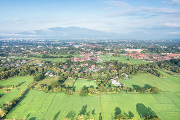 Fototapeta na wymiar Land or landscape of green field in aerial view. Land on earth for agriculture farm, farmland or plantation with texture pattern of crop, rice, paddy in Chiang mai for sale, buy or investment.