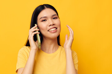 woman with Asian appearance communicates on the phone emotions studio model unaltered