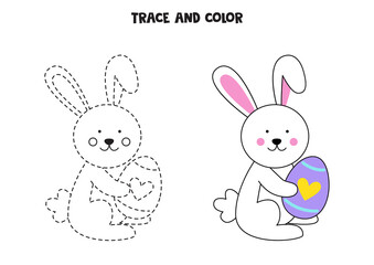 Trace and color cute Easter bunny holding an egg. Worksheet for children.